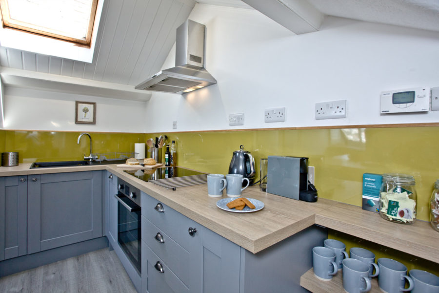 The fully-equipped kitchen has an integral dishwasher, oven and hob